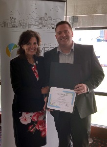 Montgomery County Board of Supervisors Chair Sherri Blevins and Montgomery County Senior Planner Justin Sanders holding his 40 under 40 award.