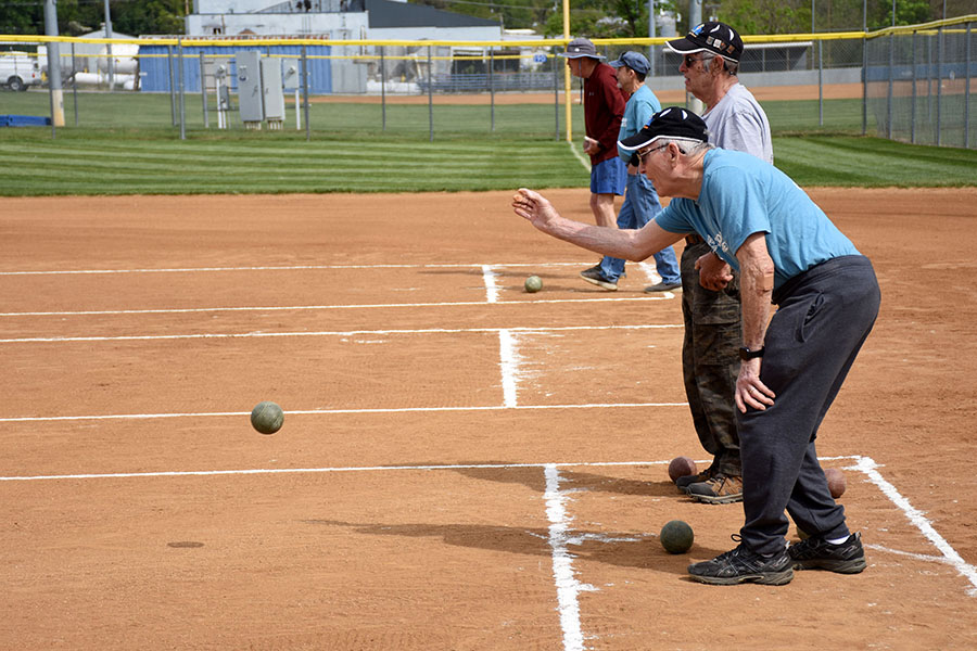 Participants tosses ball during Bocce Ball event.