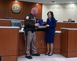 Montgomery County Board Chair, Sherri Blevins, presents School Resource Officer, Deputy Parks, with a letter of commendation for his actions in saving a child's life on Jan. 31, 2023.