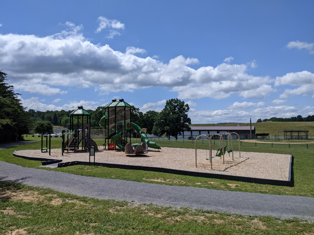 The large playground at McCoy Park is shown on a sunny summer day.