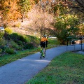A cyclist rides on the Huckleberry Trail in the fall.