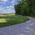 The gravel walking path at McCoy Park has very little elevation gain with trees on one side and open green space on the other side.