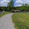 The gravel walking track at Plum Creek Park curves around the baseball field past the picnic shelter.